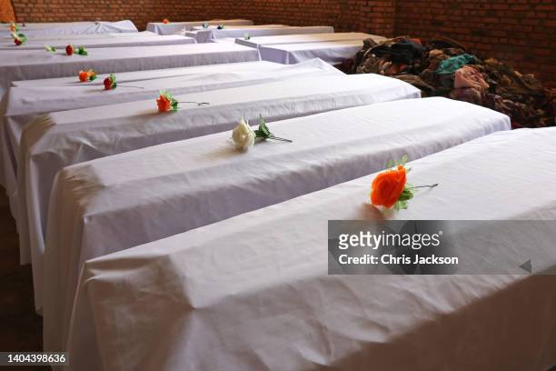 Coffins containing recently found victims with a single flower laid on them at the Nyamata Church Genocide Memorial for Victims of the 1994 Rwandan...