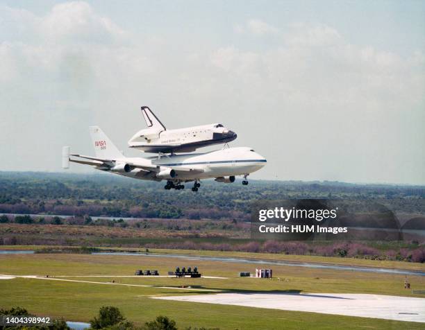 --- The Space Shuttle Challenger, atop NASA 905, approaches the runway at Kennedy Space Center following a flight from Edwards Air Force Base in...