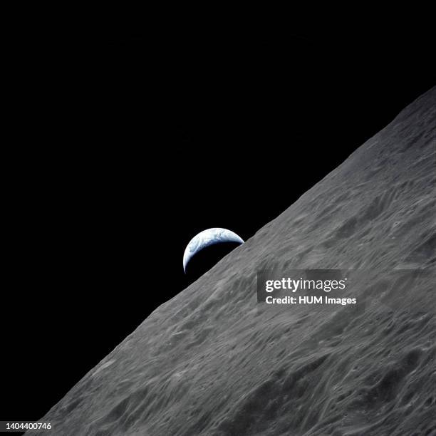 --- The crescent Earth rises above the lunar horizon in this spectacular photograph taken from the Apollo 17 spacecraft in lunar orbit during the...