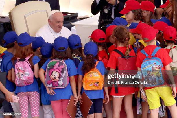 Pope Francis greets a group of children at the end of his general weekly audience in St. Peter's Square on June 22, 2022 in Vatican City, Vatican. In...