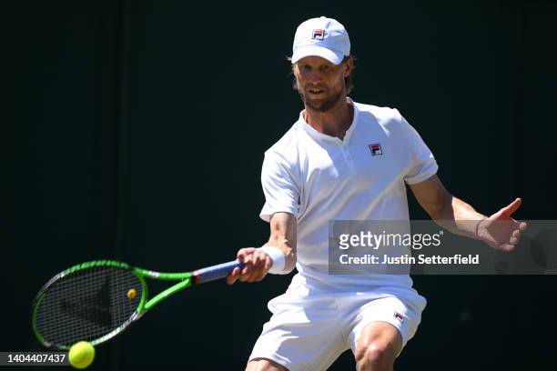 Andreas Seppi of Italy plays a forehand against Aidan McHugh of Great Britain in their Mens' Qualifying Singles match during Day 3 of Wimbledon...