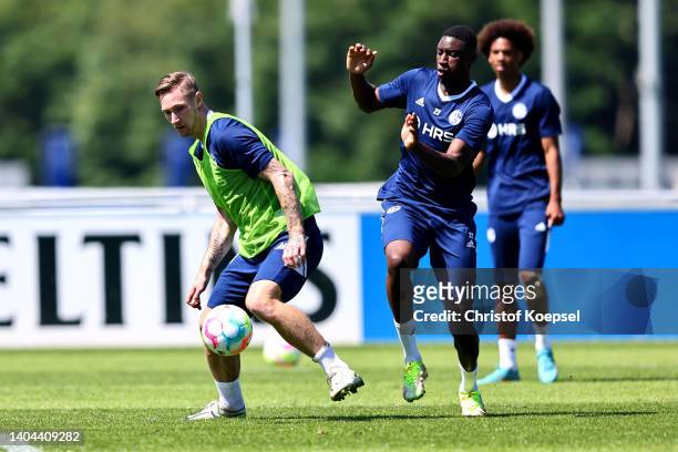 Sebastian Polter and Ibrahima Cisse attend the training session at Parkstadion on June 22, 2022 in Gelsenkirchen, Germany. FC Schalke 04 returned to...