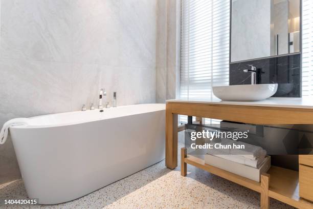 spacious and bright washroom sink and bathtub - clean bathroom stock pictures, royalty-free photos & images