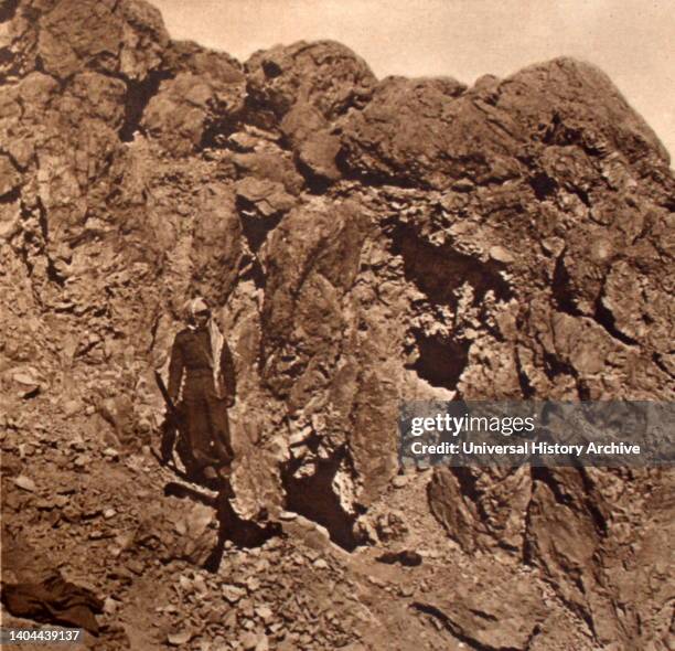 The Dead Sea Scrolls. Excavating for fragments of the Bible scrolls in a cave at Kalia near the Dead Sea, Jericho, Palestine. The entrances to the...