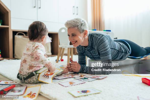 mother exercise with her baby at home - stay at home mum stock pictures, royalty-free photos & images