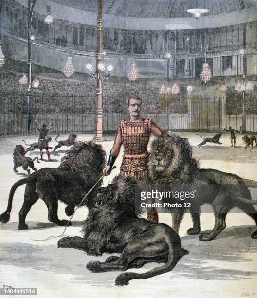Spectacular production at the Hippodrome, Paris, reminiscent of a Roman circus in the time of Nero. Lion tamer posing with three lions. From 'Le...