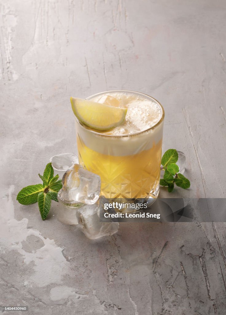 Citrus cocktail with foam on gray background