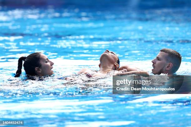 Anita Alvarez of Team United States is attended to by USA's coach Andrea Fuentes and medical staff following her Women's Solo Free Final performance...