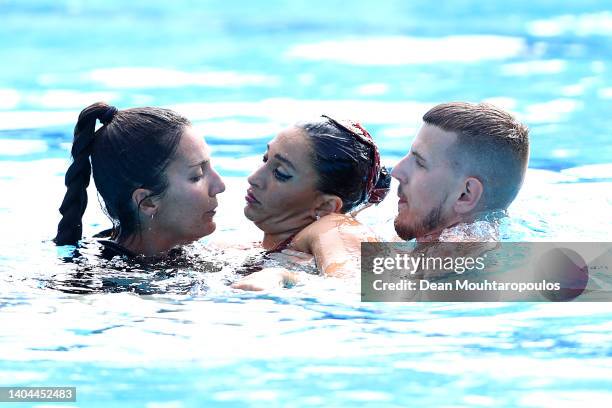 Anita Alvarez of Team United States is attended to by USA's coach Andrea Fuentes and medical staff following her Women's Solo Free Final performance...