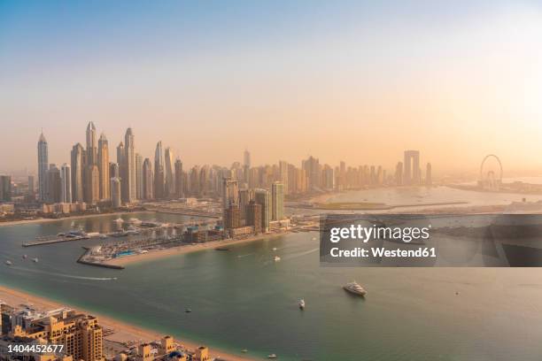 united arab emirates, dubai, view of coastal city at sunset - dubai marina stock pictures, royalty-free photos & images