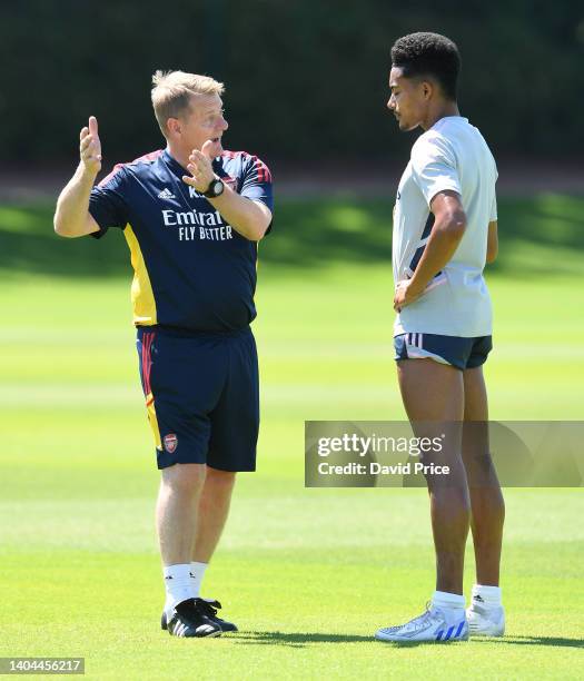 Ken Gillard the Arsenal Academy U23 and Loans Coach chats to Miguel Azeez of Arsenal during the Arsenal U23 training session at London Colney on June...