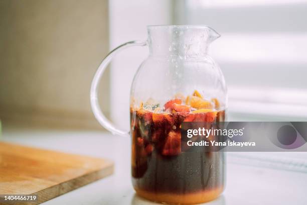 sweet cold summer refreshing cocktail drink a glass jug - ponche fotografías e imágenes de stock