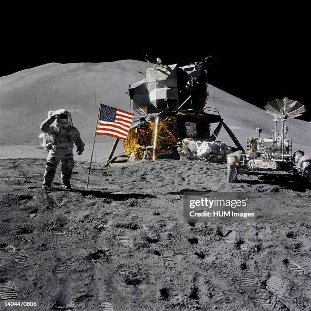 --- Astronaut James B. Irwin, lunar module pilot, gives a military salute while standing beside the deployed United States flag during the Apollo 15...