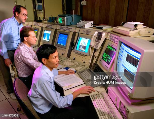 Workers at NASA's Lewis Research Center - viewing information on computer monitors in 1996.