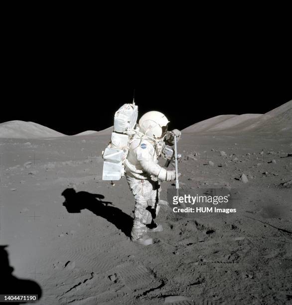 Astronaut Harrison Schmitt collects lunar rake samples during EVA.