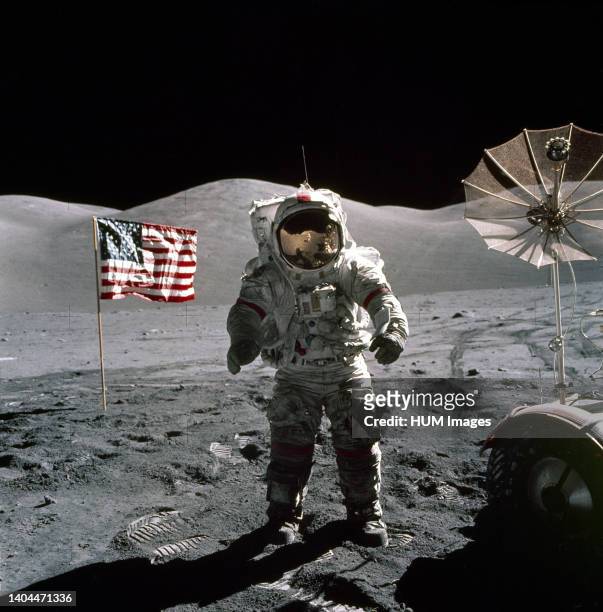 This is an Apollo 17 Astronaut standing upon the lunar surface with the United States flag in the background.