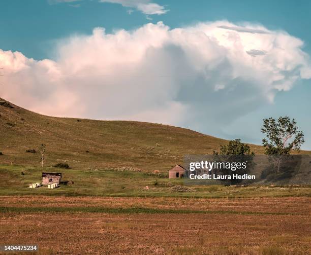 old abandoned structures on the great plains with impending storms - farmhouse stock pictures, royalty-free photos & images