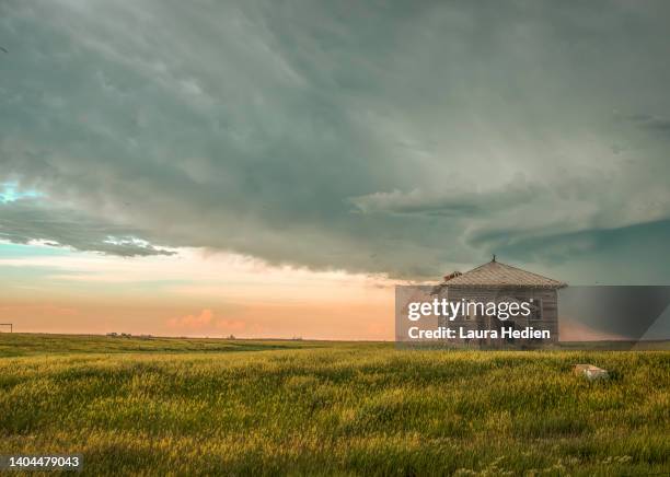 old abandoned structures on the great plains with impending storms - ominous stock pictures, royalty-free photos & images
