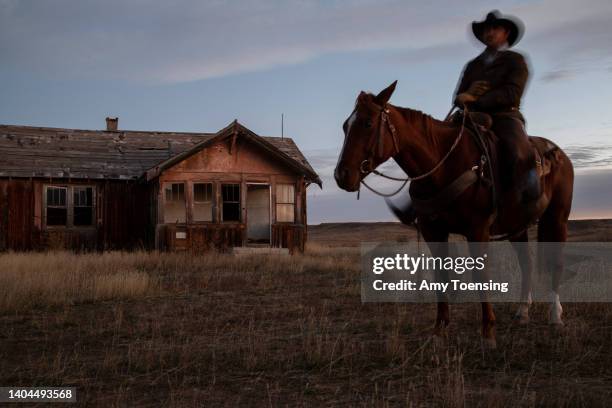 Wayne French, whose family first homesteaded in central Montana more than a century ago, on his horse as the sun rises, waiting to round up his...