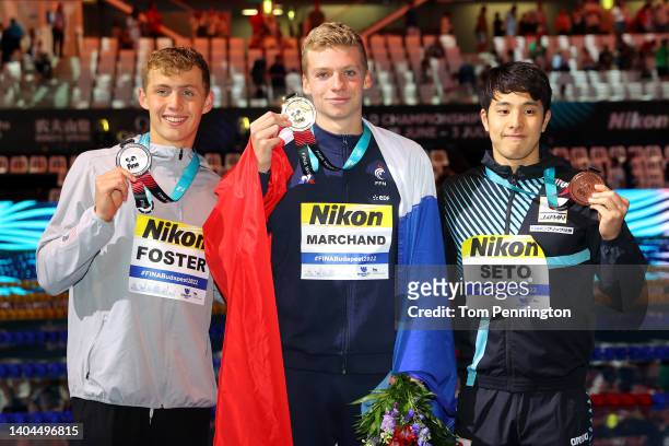 Silver medalist, Carson Foster of Team United States, Gold medalist, Leon Marchand of Team France and Daiya Seto of Team Japan pose with their medals...