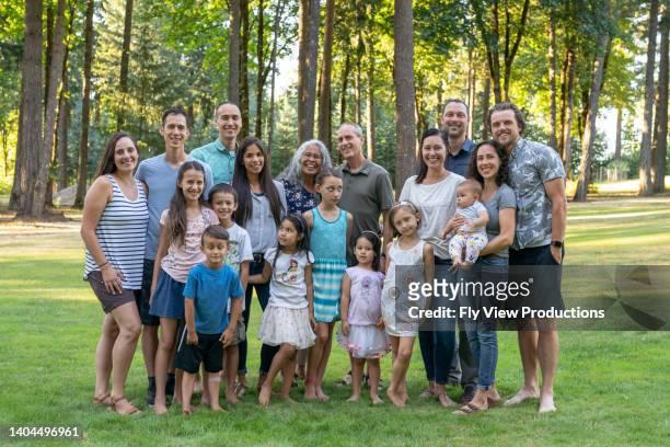multi-generation family celebrating reunion together outdoors - large family stock pictures, royalty-free photos & images