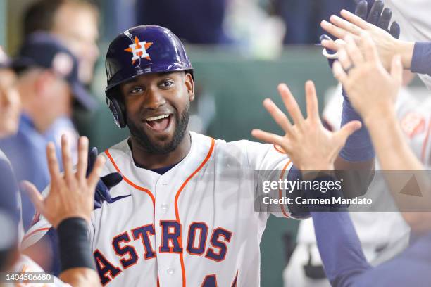 Yordan Alvarez of the Houston Astros high fives teammates after hitting a home run during the third inning against the New York Mets at Minute Maid...