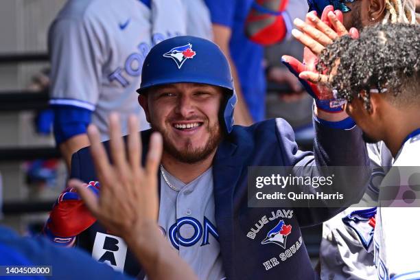 Alejandro Kirk of the Toronto Blue Jays celebrates in the dugout with teammates after his home run in the third inning against the Chicago White Sox...