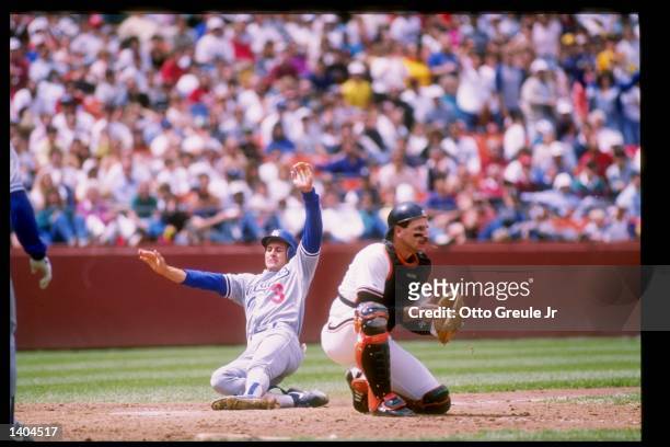 Second baseman Steve Sax of the Los Angeles Dodgers slides into a base during a game against the San Francisco Giants at Candlestick Park in San...