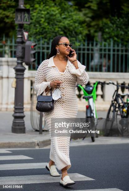 Guest is seen wearing creme white dress, black bag outside Lemaire during Paris Fashion Week - Menswear Spring/Summer 2023 on June 22, 2022 in Paris,...
