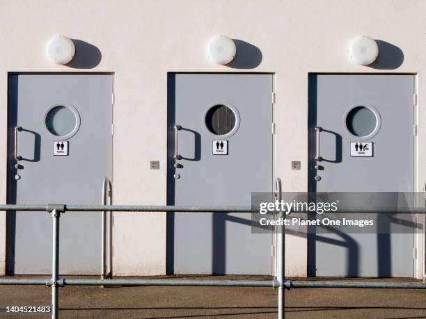 Public toilets doors in Abingdon Abbey Field Park, first light of winter dawn j1.