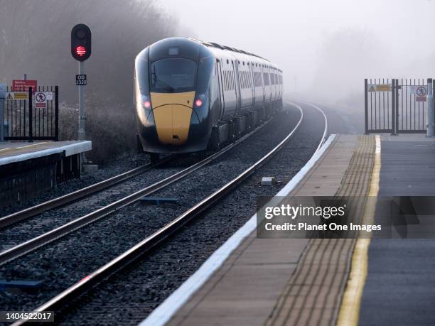 Passenger train leaving Radley Station during rush hour, misty Autumn morning during the pandemic n3.