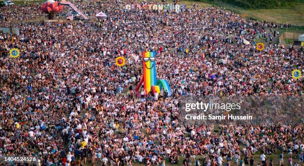 General view of festival goers by the Glastonbury sign during day one of Glastonbury Festival at Worthy Farm, Pilton on June 22, 2022 in Glastonbury,...