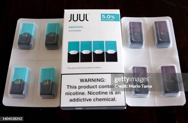 In this photo illustration, packages of Juul e-cigarettes sit on a table on June 22, 2022 in Los Angeles, California. The Food and Drug...