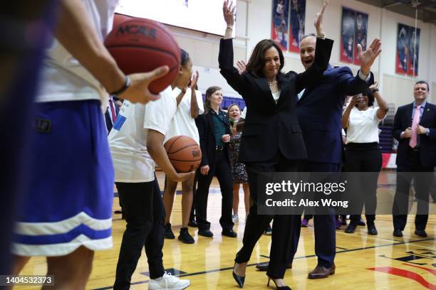 Vice President Kamala Harris celebrates with her husband Doug Emhoff as she plays basketball with schoolgirls during a Title IX 50th Anniversary...