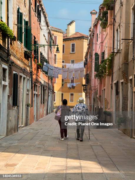 Two old women walking along Sotoportego de le Colone in Venice 4.