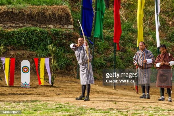 Bhutanese archer competes with a recurved bow in an archery competition in Thimphu, Bhutan.