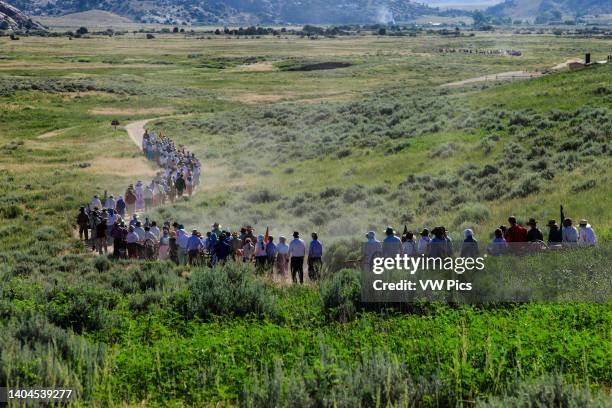 Group of teenaged young people re-enact a Mormon pioneer handcart trek on the plains of Wyoming.