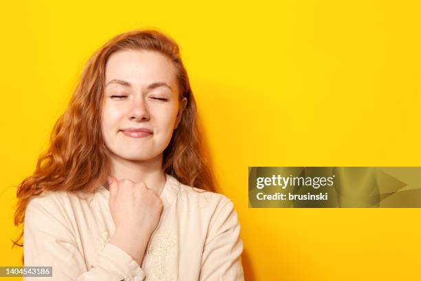 studio portrait of a 24 year old red-haired woman - beige blouse stock pictures, royalty-free photos & images