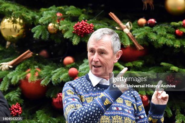 Nigel Evans, Conservative MP for Ribble Valley, wearing a Houses of Parliament Christmas jumper stands by the Christmas tree outside No.10 Downing...