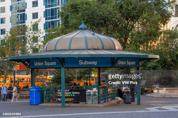 People enjoying leisure time in Union Square, New York in from of the Union Square Subway Station..