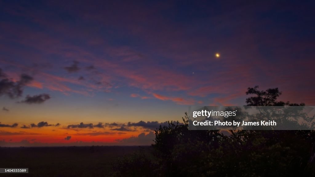 The moon, a star, and sunrise in the Glades