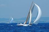 White yacht with large white sail