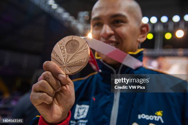 Diego Duenas, Paracycling bronze medallist poses for a photo with his medal during a welcoming event to Colombia's Paralympic athletes that...