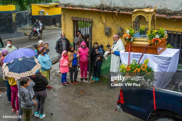 Priest prays and says a prayer with the relic of the Blessed in a popular area of Caracas. Relic of Blessed Jose Gregorio Hernandez. Caracas,...