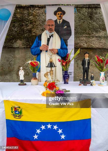 Priest prays and says a prayer with the relic of the Blessed in a popular area of Caracas. Relic of Blessed Jose Gregorio Hernandez. Caracas,...