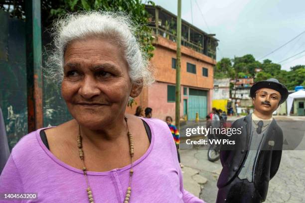 Woman with an image of Blessed Jose Gregorio Hernandez in a poor neighborhood in Caracas. Relic of Blessed Jose Gregorio Hernandez. Caracas,...