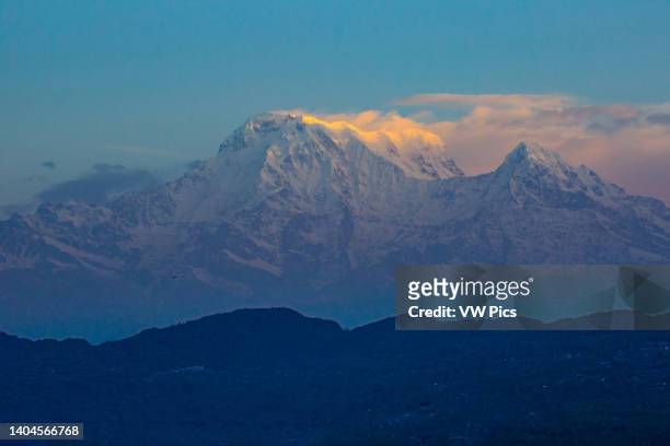 First light on the crest of Annapurna South with Hiunchuli at right. Nepalese Himalayas near Pokhara, Nepal.
