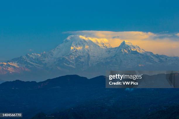 First light at sunrise Annapurna South with Hiunchuli at right. Nepalese Himalayas near Pokhara, Nepal.