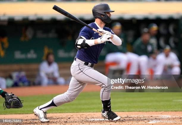 Jesse Winker of the Seattle Mariners hits an RBI single scoring Julio Rodriguez against the Oakland Athletics in the top of the third inning at...