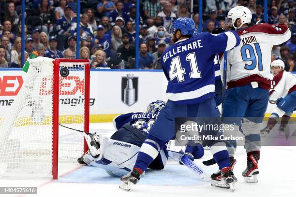 Pierre-Edouard Bellemare of the Tampa Bay Lightning and Nazem Kadri of the Colorado Avalanche watch as the puck hits the post during overtime in Game...